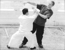 Alex on the receiving end of Master Chen's  peng/ward off energy.